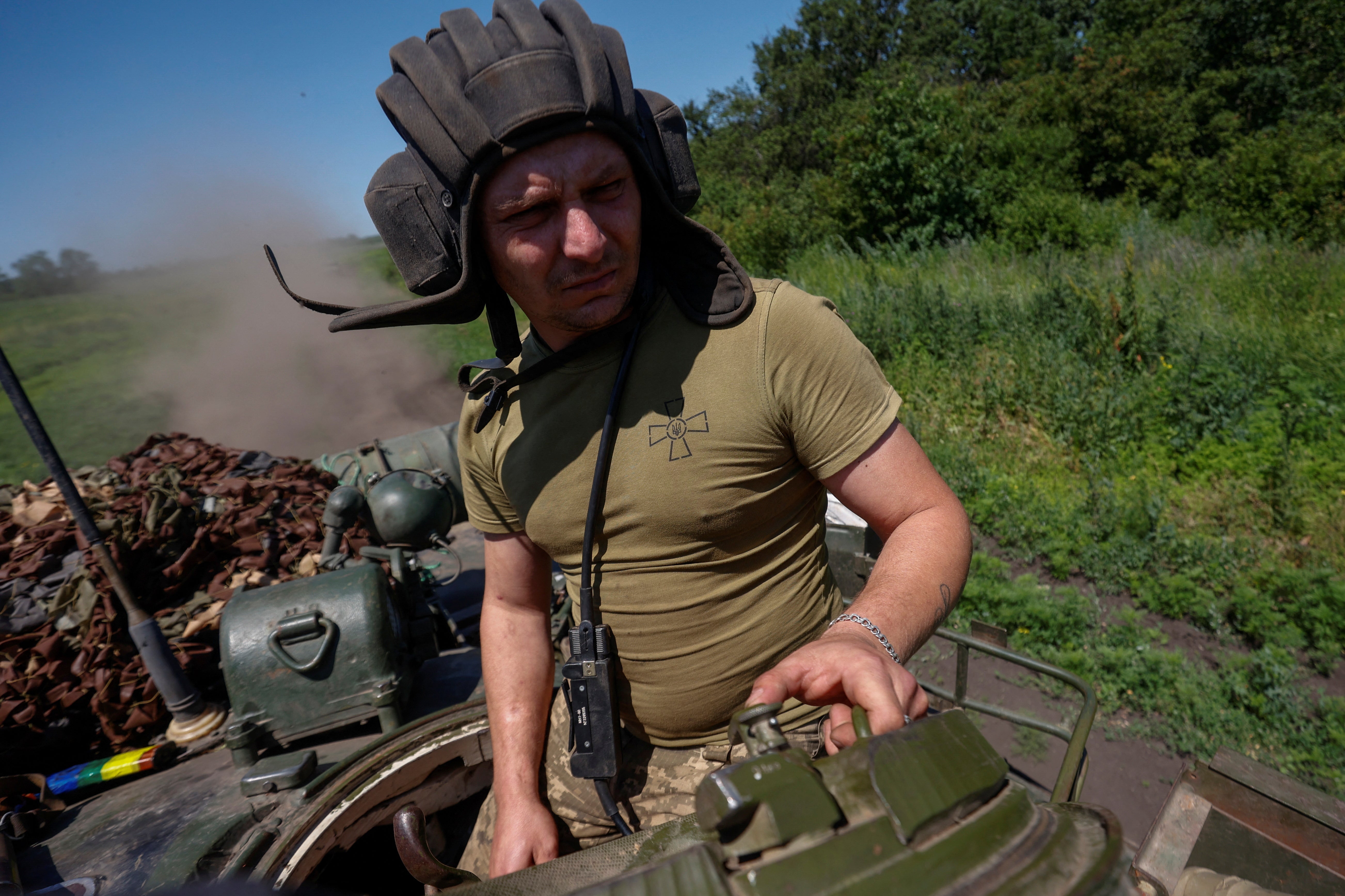 A Ukrainian serviceman rides in a T-80 battle tank captured from Russian troops near Bakhmut