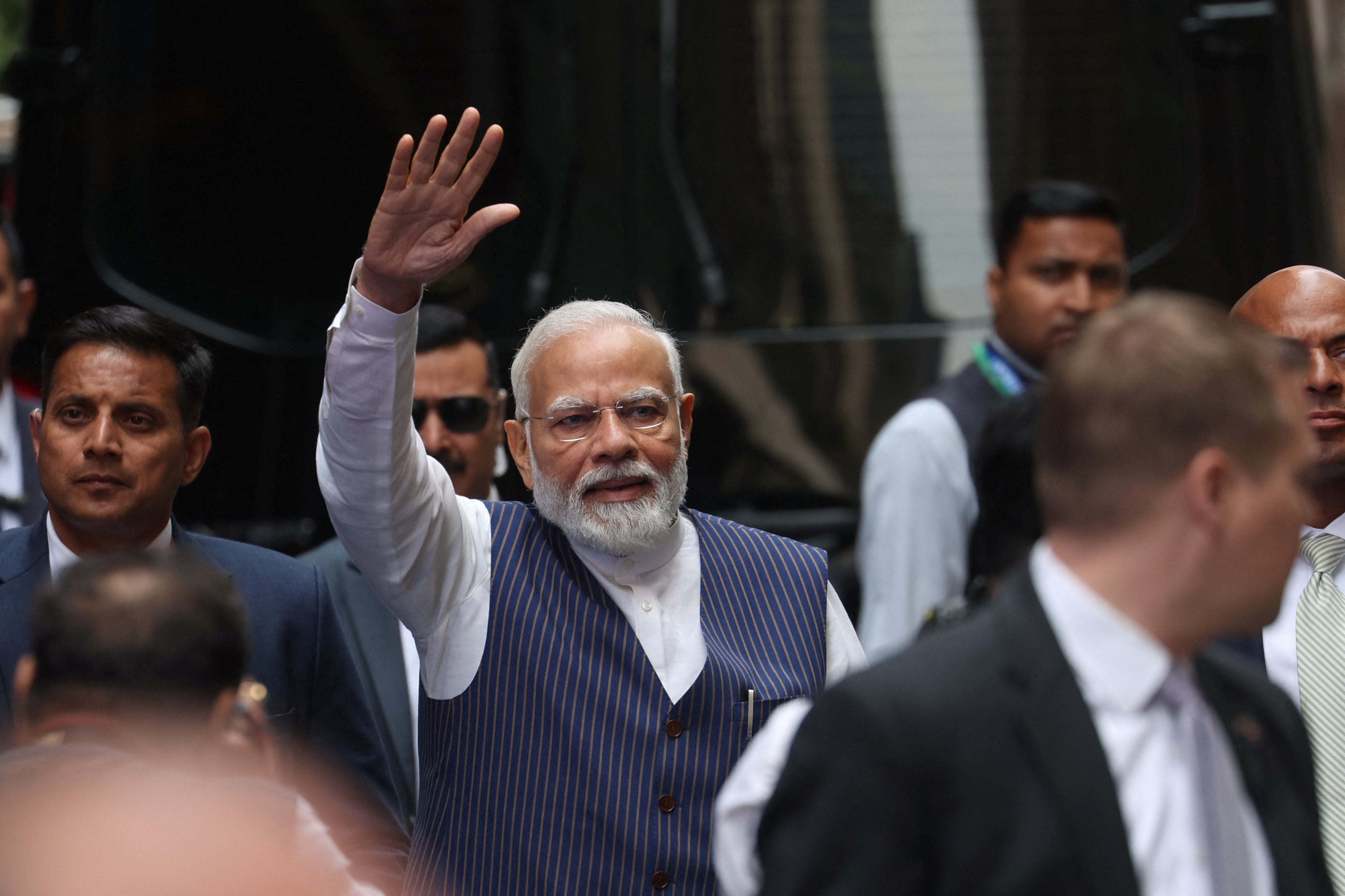 Narendra Modi waves to supporters as he arrives at the Lotte hotel in New York City on 20 June