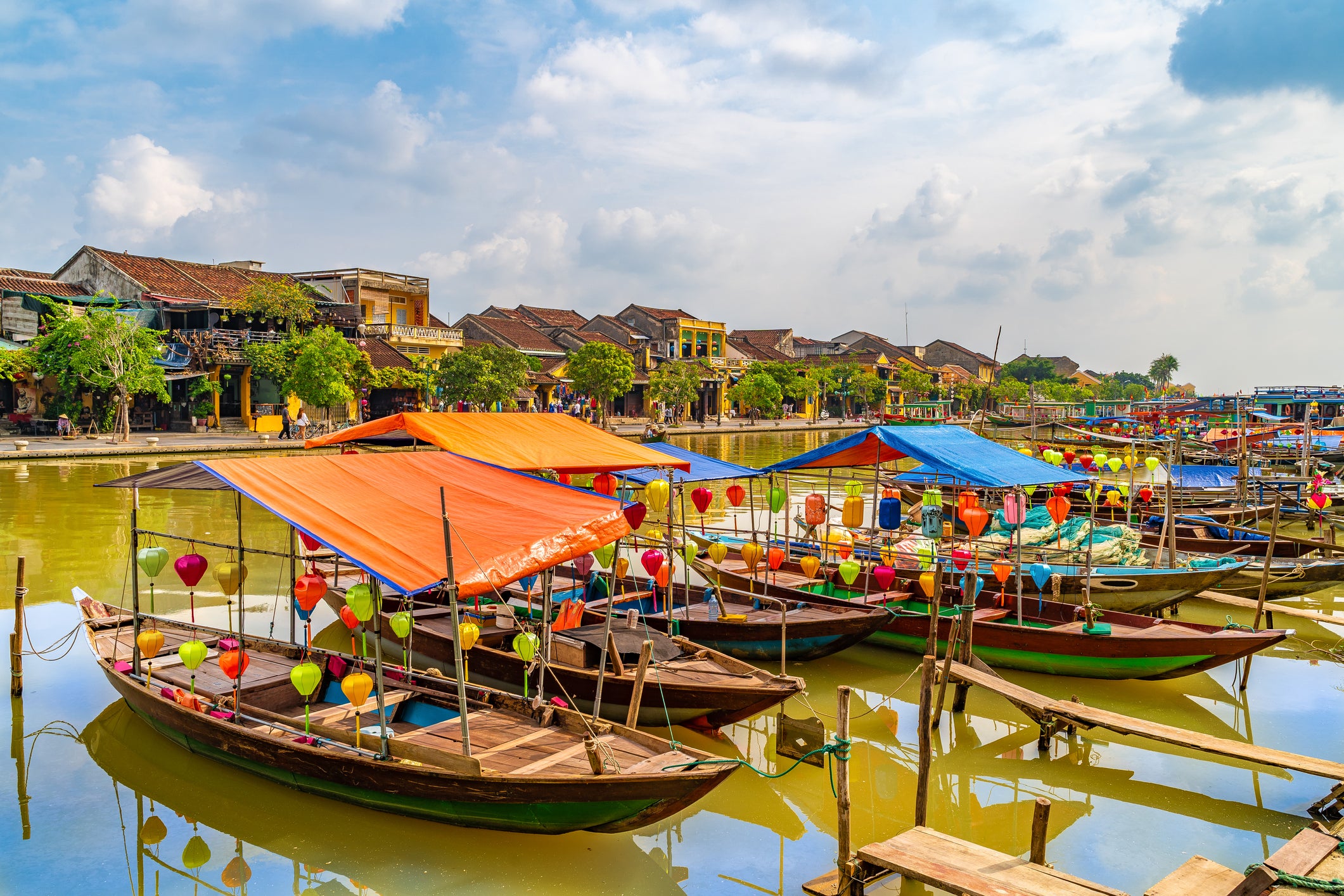Colourful lanterns decorate wooden boats on the Thu Bon River in Hoi An