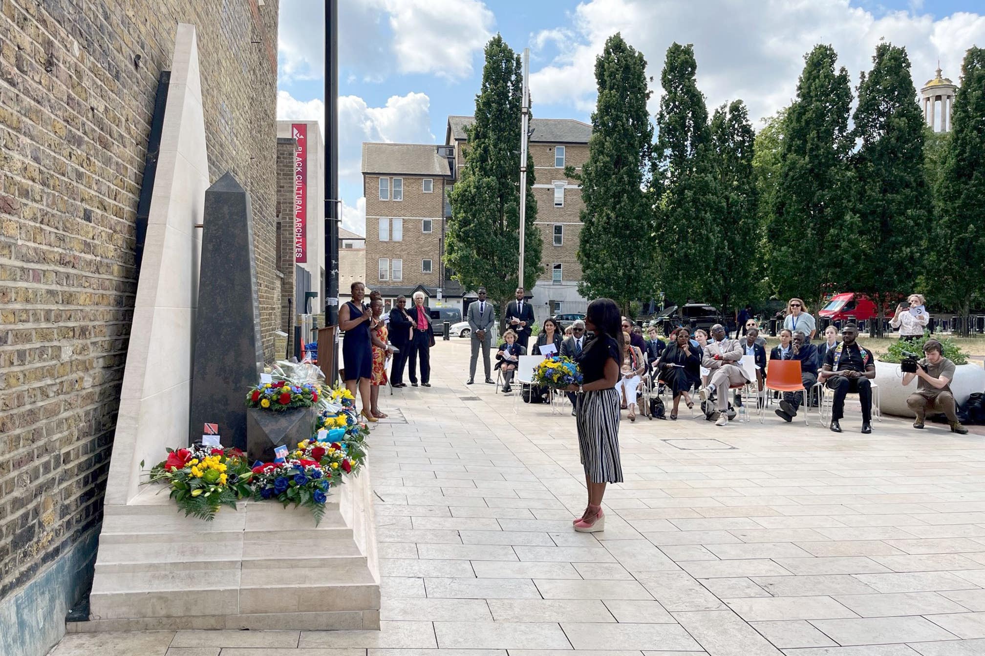 Flowers were laid at the Windrush Square memorial during the service (Harry Stedman/PA)