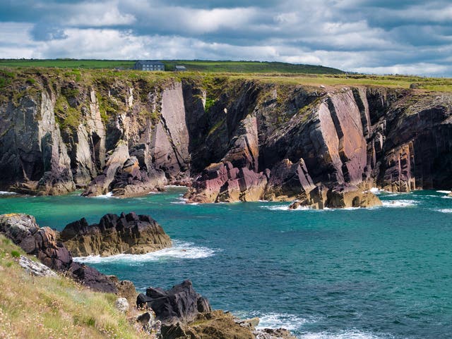 <p>Leap across rocks along the Pembrokeshire coastal path on a coasteering trip </p>