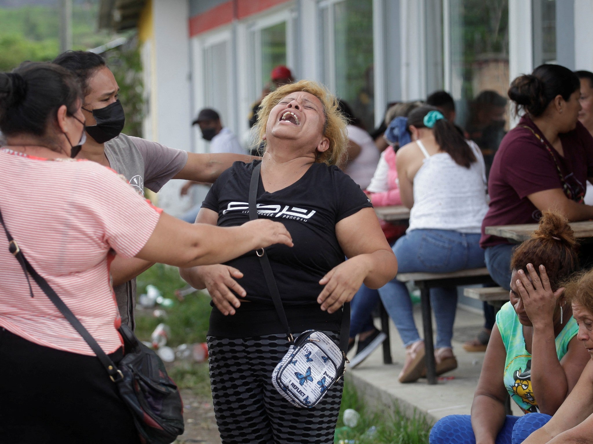 The relative of an inmate cries as others comfort her as they wait for news about their loved ones outside the women’s prison that is the site of the latest riot