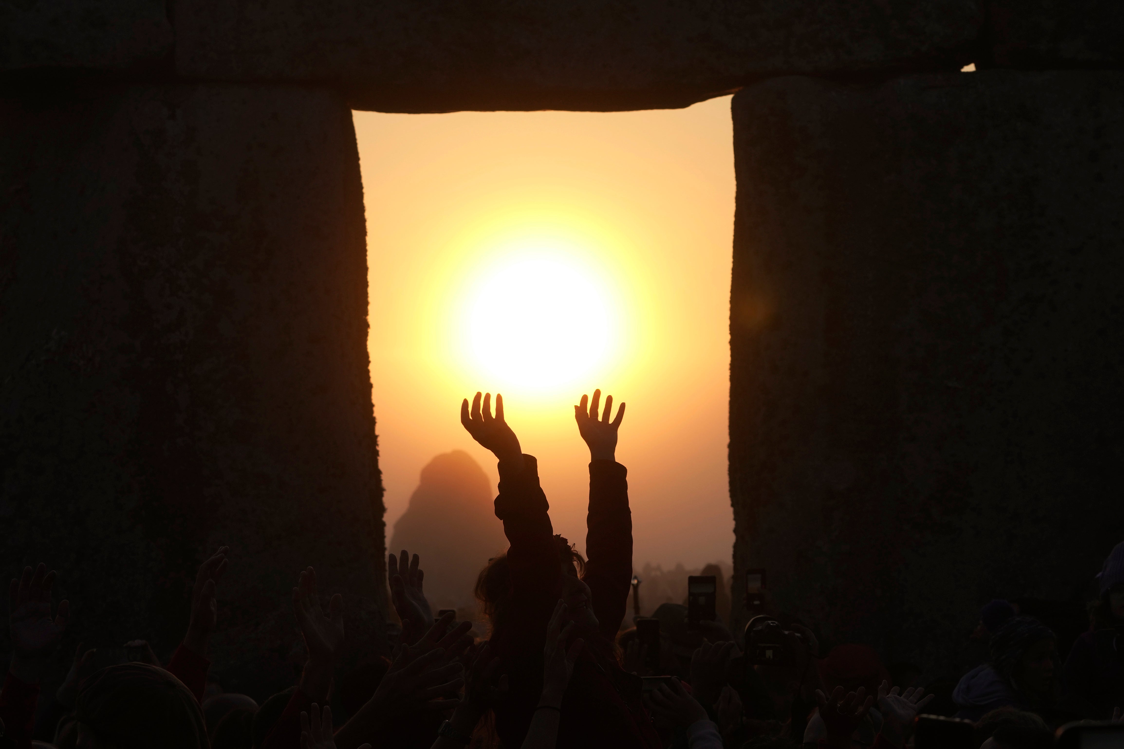 Revelers gather at the ancient stone circle Stonehenge to celebrate the Summer Solstice, the longest day of the year, near Salisbury