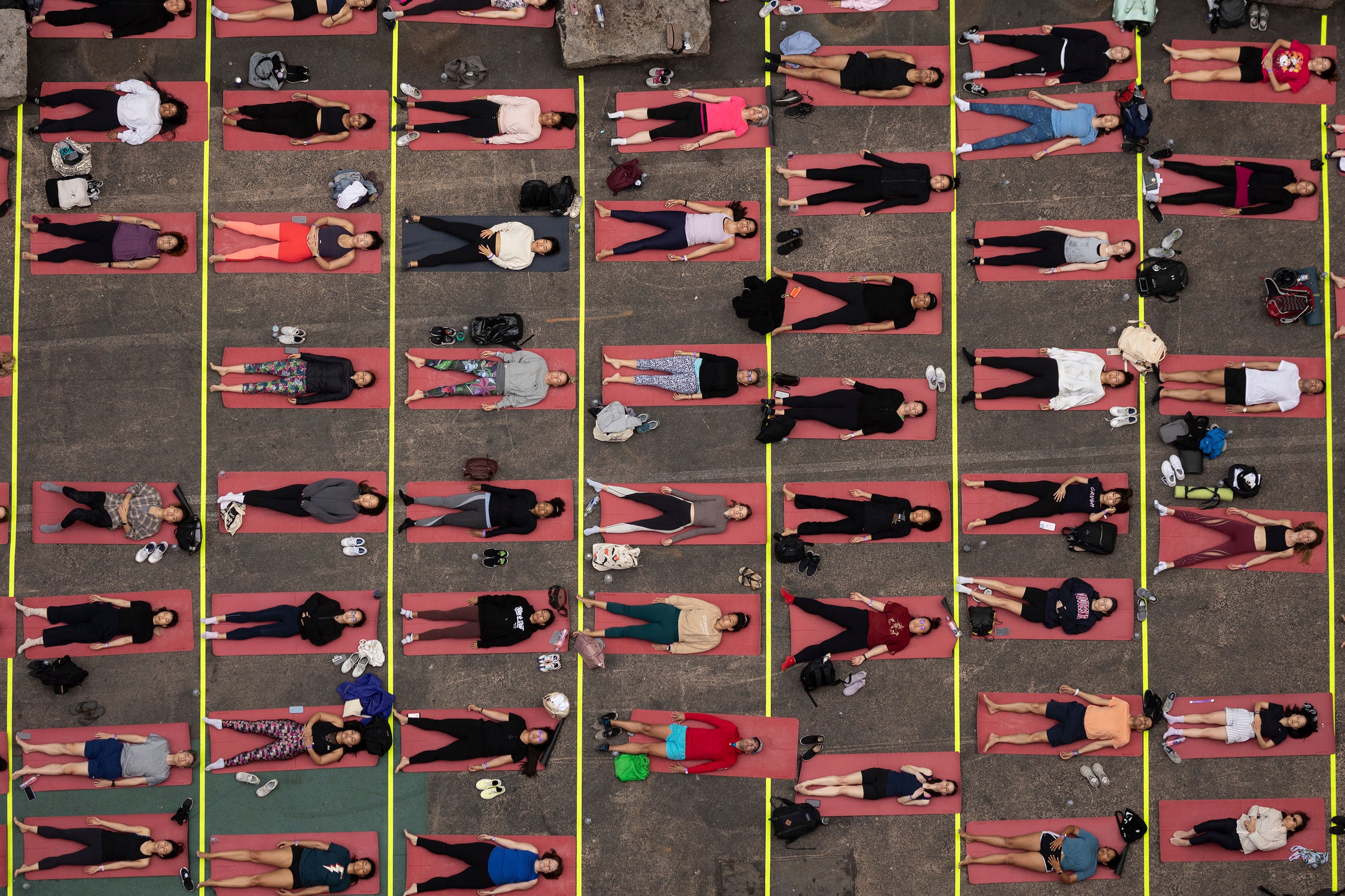 People participate in a yoga class during the “Times Square: Mind Over Madness Yoga” event, to celebrate the summer solstice in New York