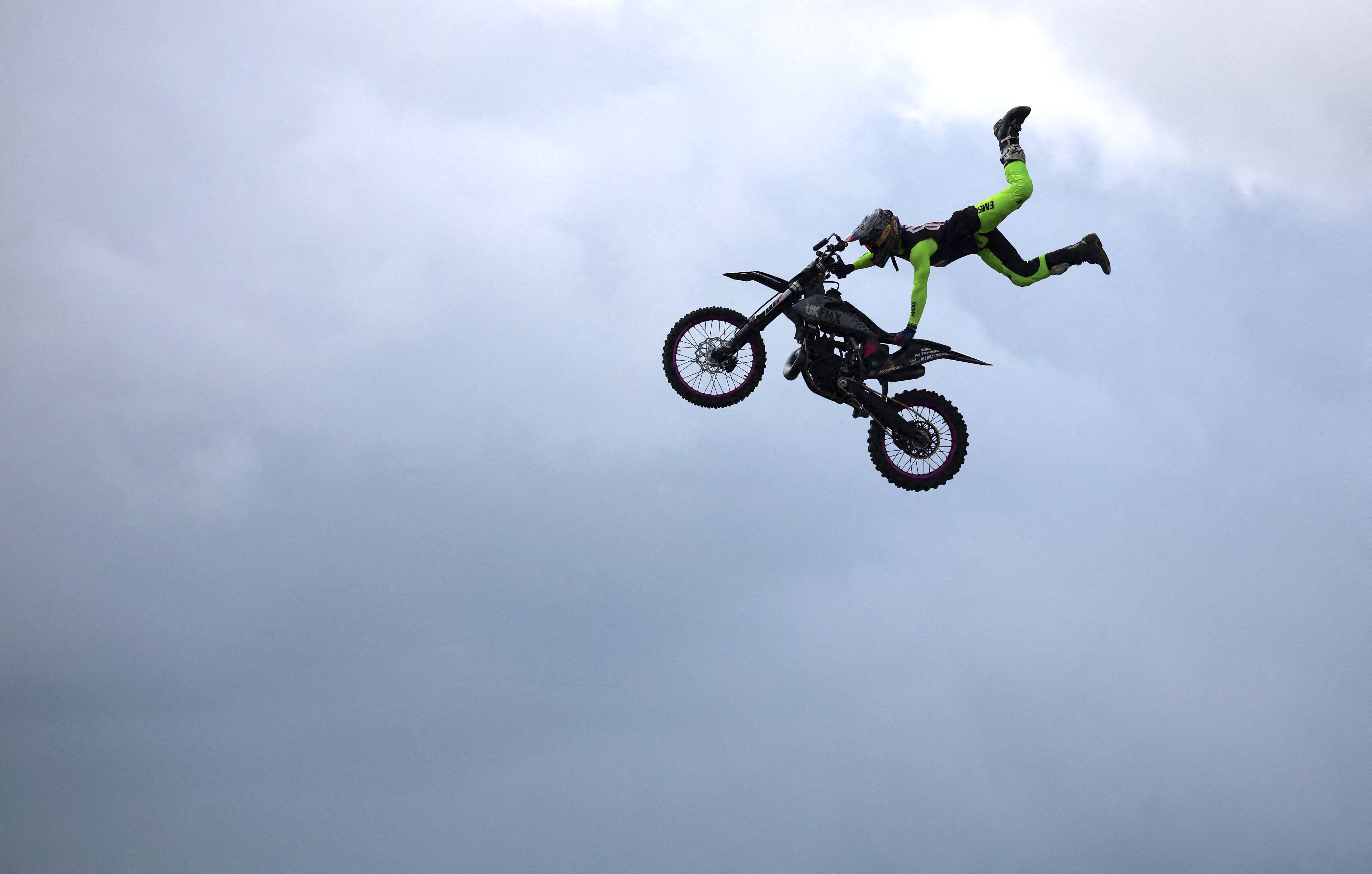 A rider from the Extreme Bike Battle display team performs a stunt as part of the Royal Cheshire County Show near Knutsford