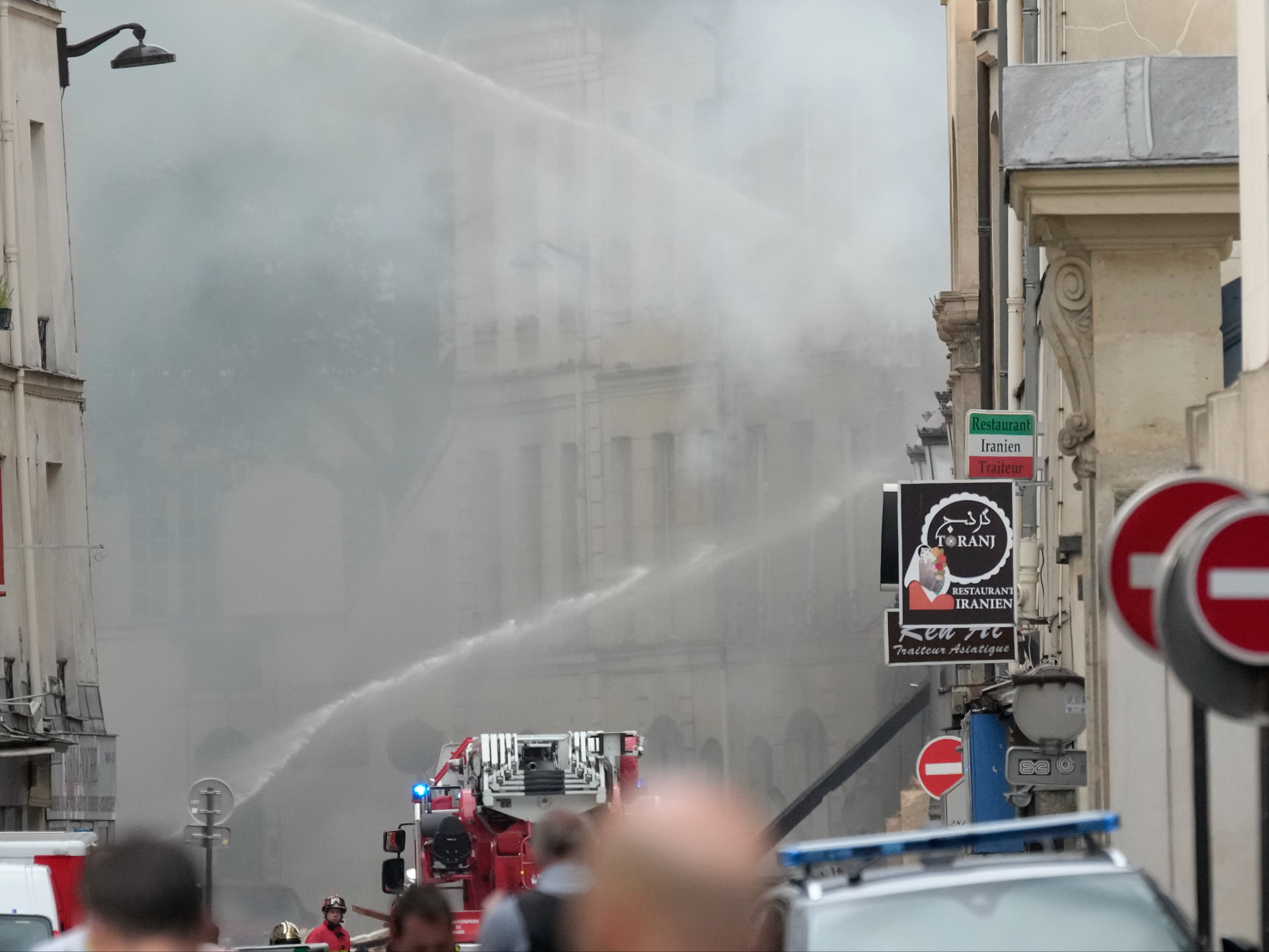 Firemen use a water canon to put out the blaze