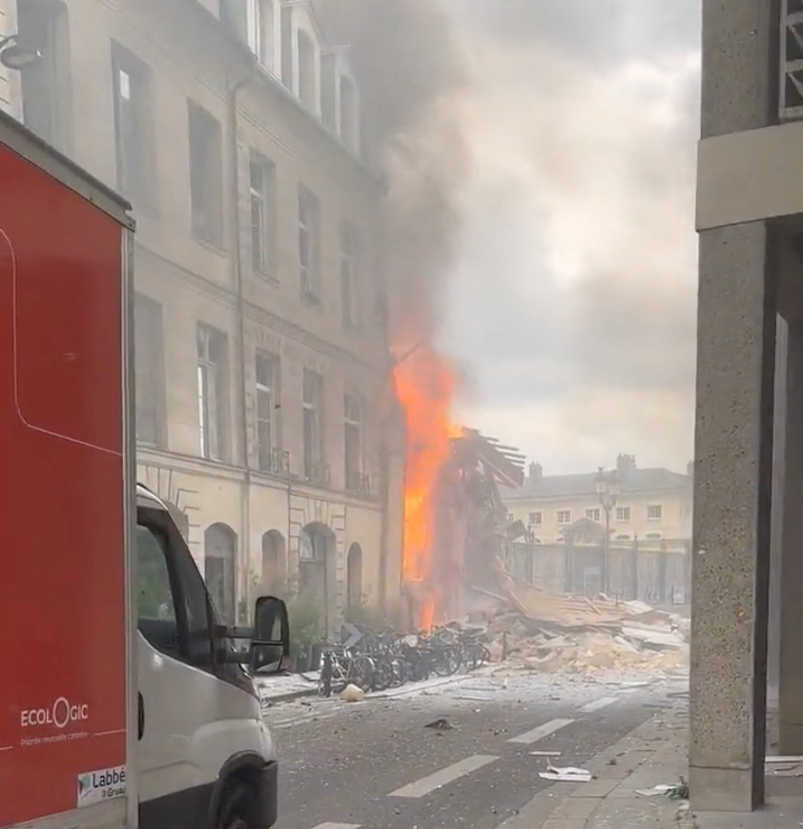 Flames and smoke erupt from a building