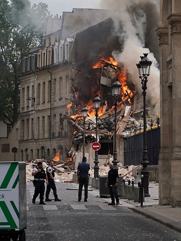 Smoke billows from the rubble of the building at Place Alphonse-Laveran in the 5th arrondissement of Paris on 21 June 2023