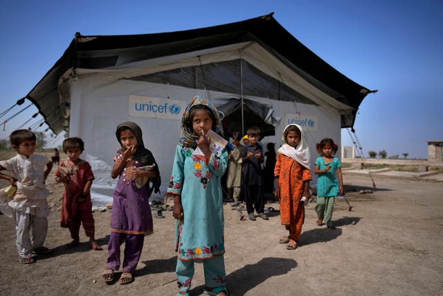 <p>Flood victims leave a school set up in a tent, caused by last year's floods, in Arzi Naich village in Dada, a district of Pakistan's Sindh province</p>