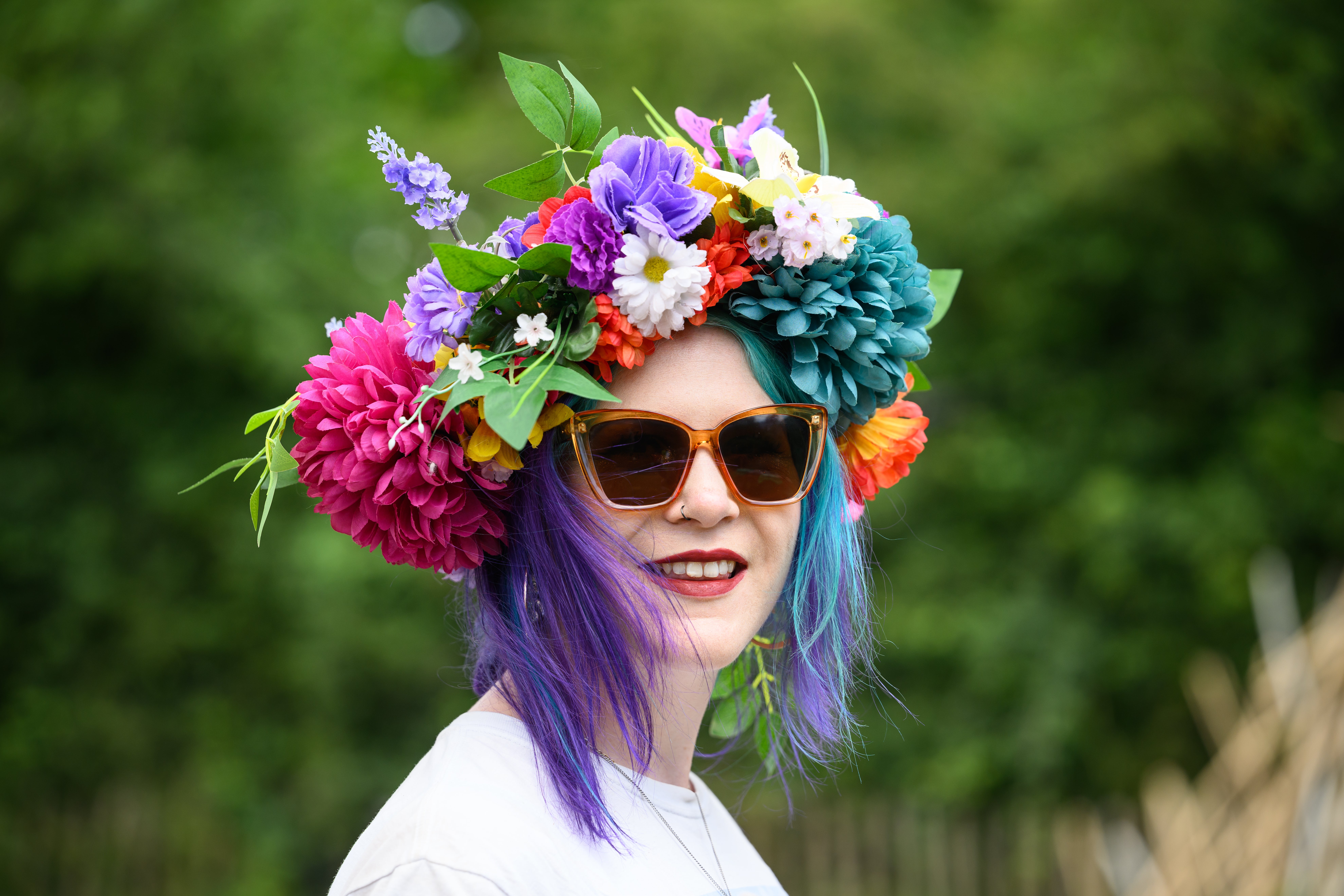Pat Watling from the Isle of Man poses for a photo wearing her homemade floral hat on day one of Glastonbury Festival 2023