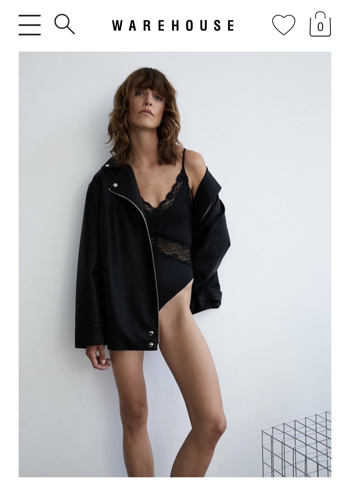 Warehouse advert featuring a model wearing an oversized jacket and bodysuit