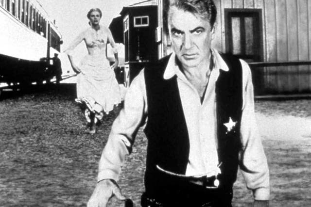 <p>Gary Cooper and Grace Kelly in ‘High Noon’ </p>