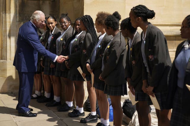 The King meets with members of the choir from the St Martin-in-the-Fields High School for Girls (Andrew Matthews/PA)