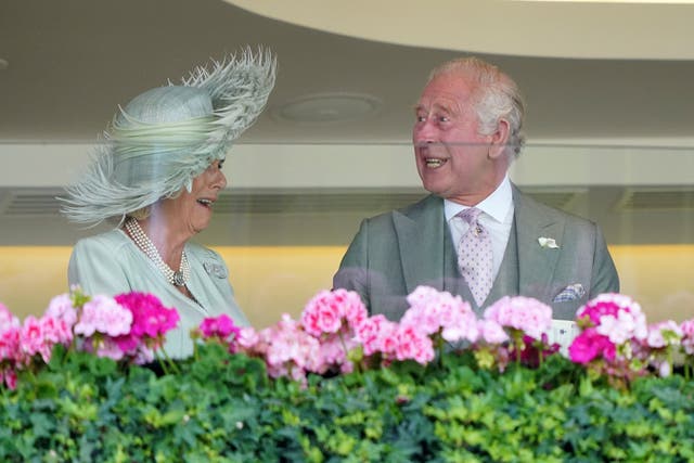 The King and Queen celebrate after Desert Hero wins the King George V Stakes (Jonathan Brady/PA)