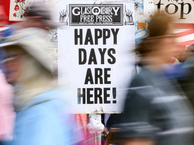 <p>A sign reading Happy Days Are Here! at Glastonbury</p>