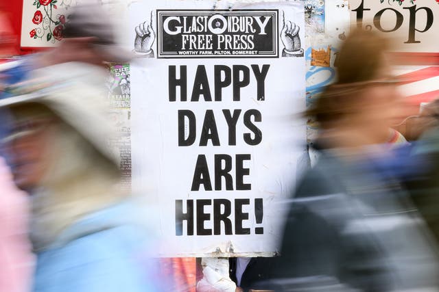<p>A sign reading Happy Days Are Here! at Glastonbury</p>