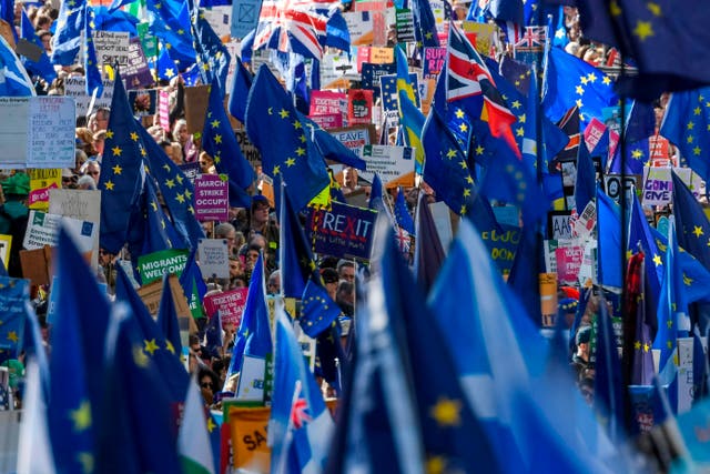 <p>Demonstrators hold placards and EU and Union flags as they take part in a march by the People’s Vote organisation in central London on October 19, 2019, calling for a final say in a second referendum on Brexit</p>