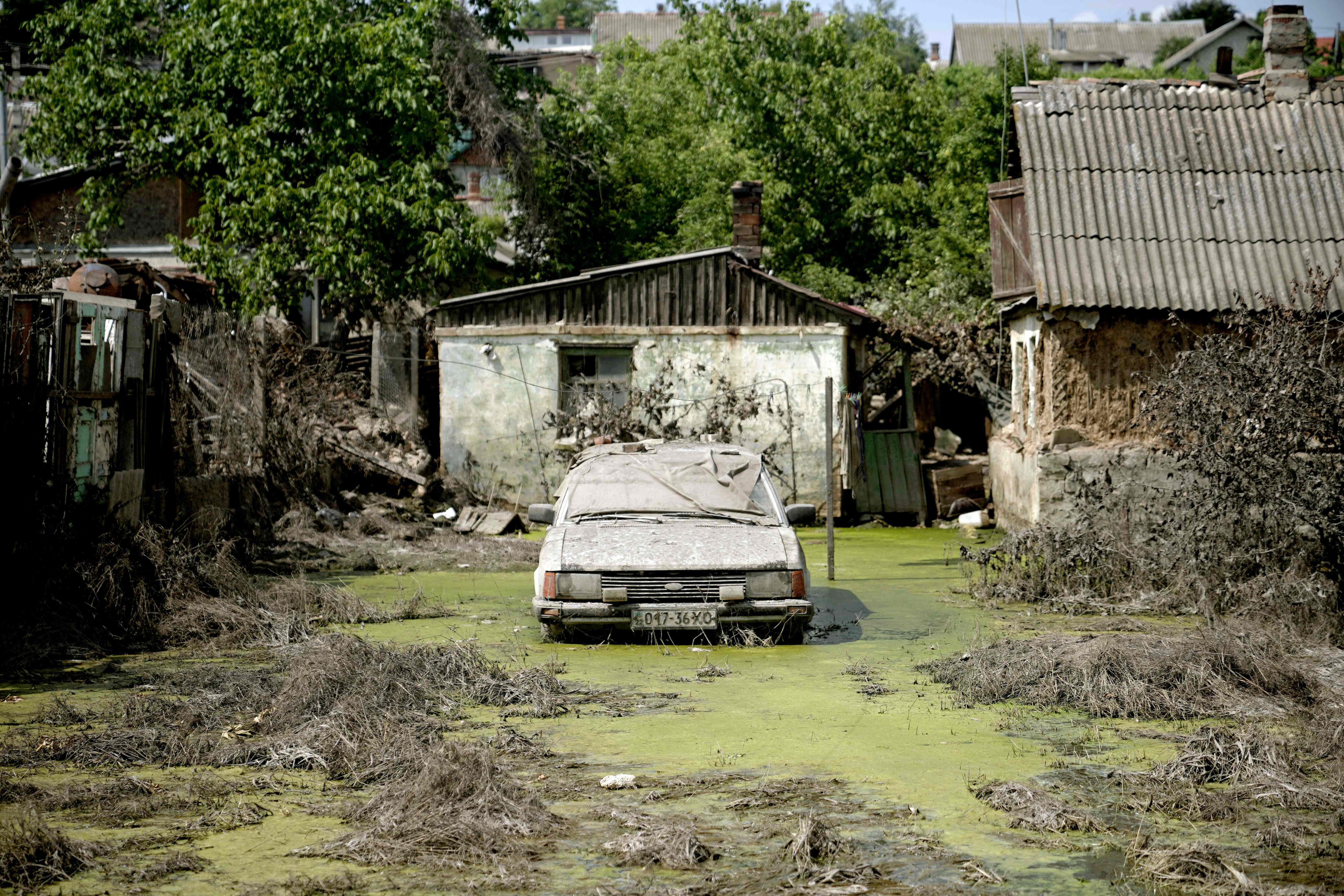 An abandoned car in Kherson in an area flooded by rising water following the collapse of the Kakhovka hydroelectric power plant dam
