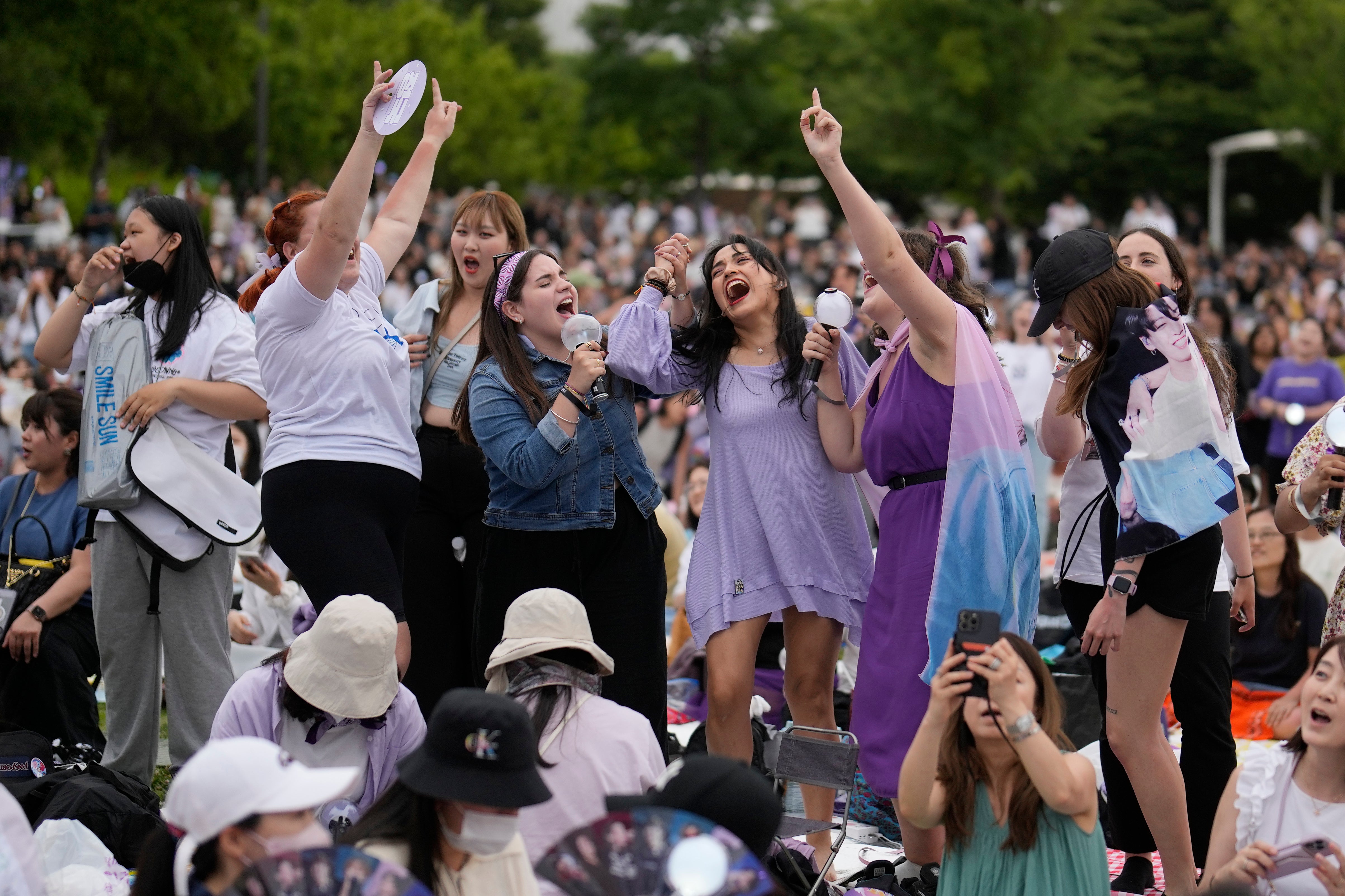 Fans of BTS gather during an event to celebrate the 10th debut anniversary of K-pop band BTS at a public park near the Han River in Seoul, South Korea, Saturday, June 17, 2023