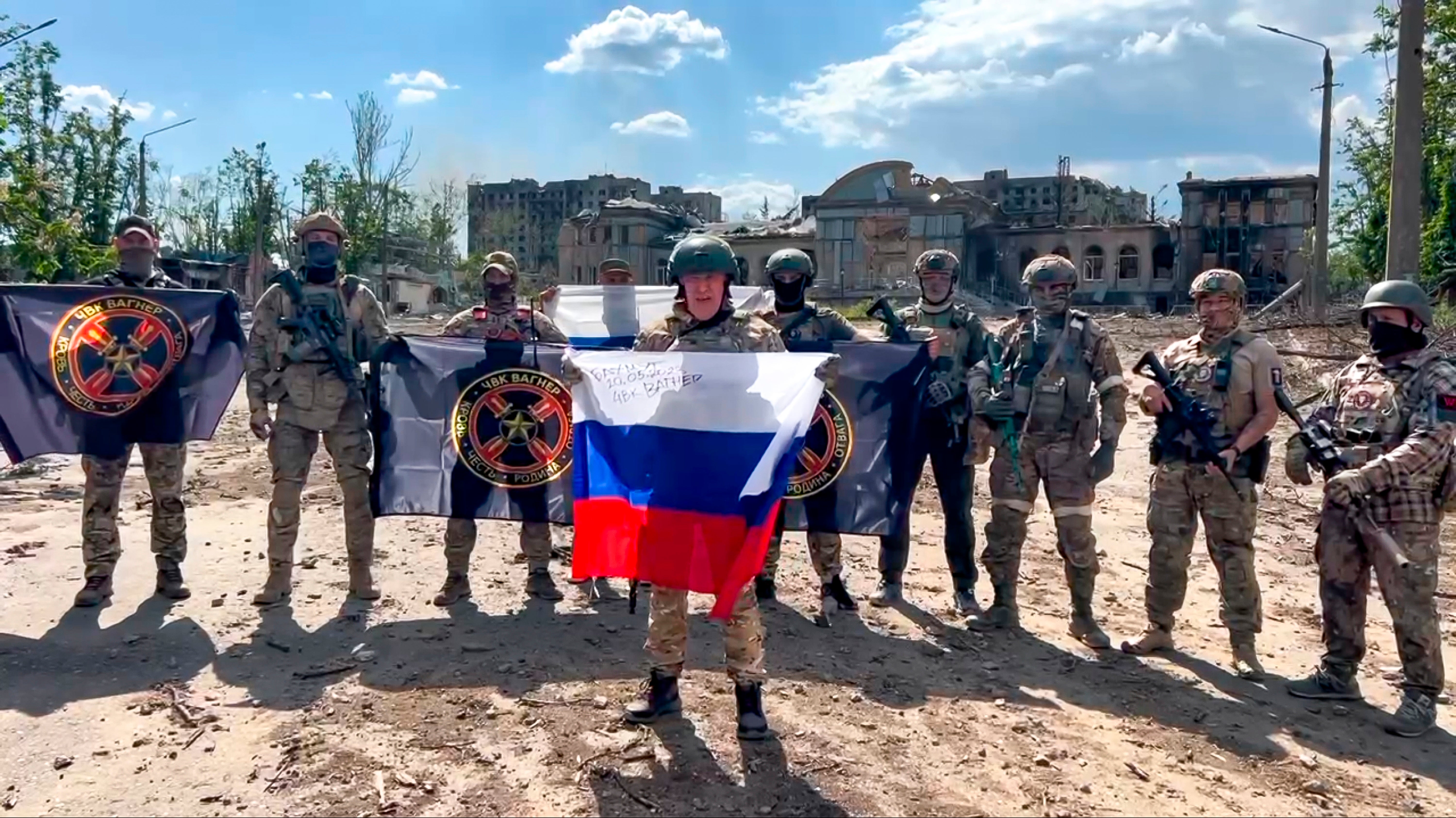 Yevgeny Prigozhin, the head of the Wagner Group military company speaks holding a Russian national flag in front of his soldiers in Bakhmut