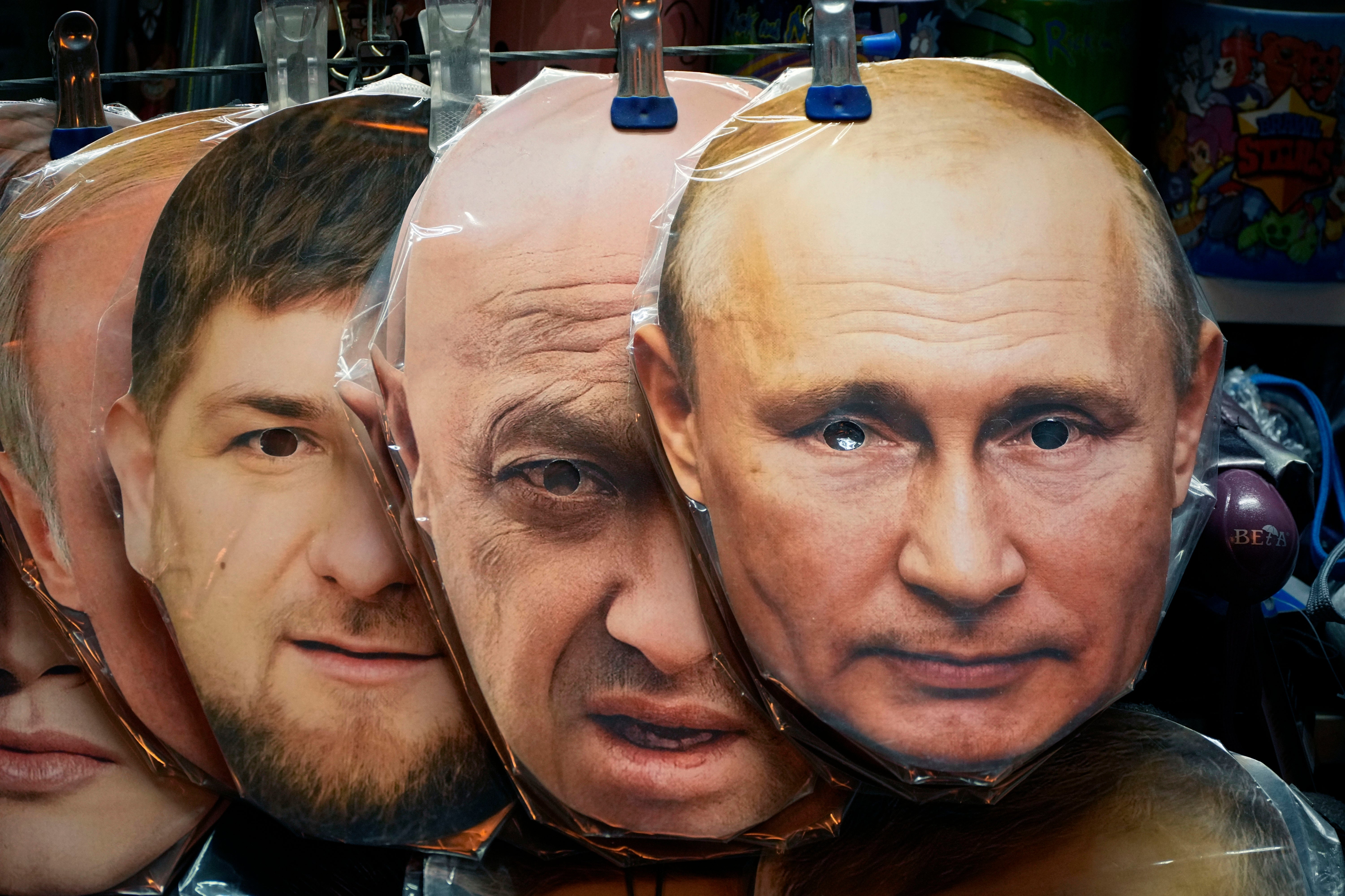 Masks showing the faces of Putin, Prigozhin and Chechnya's regional leader Ramzan Kadyrov at a souvenir shop in St Petersburg