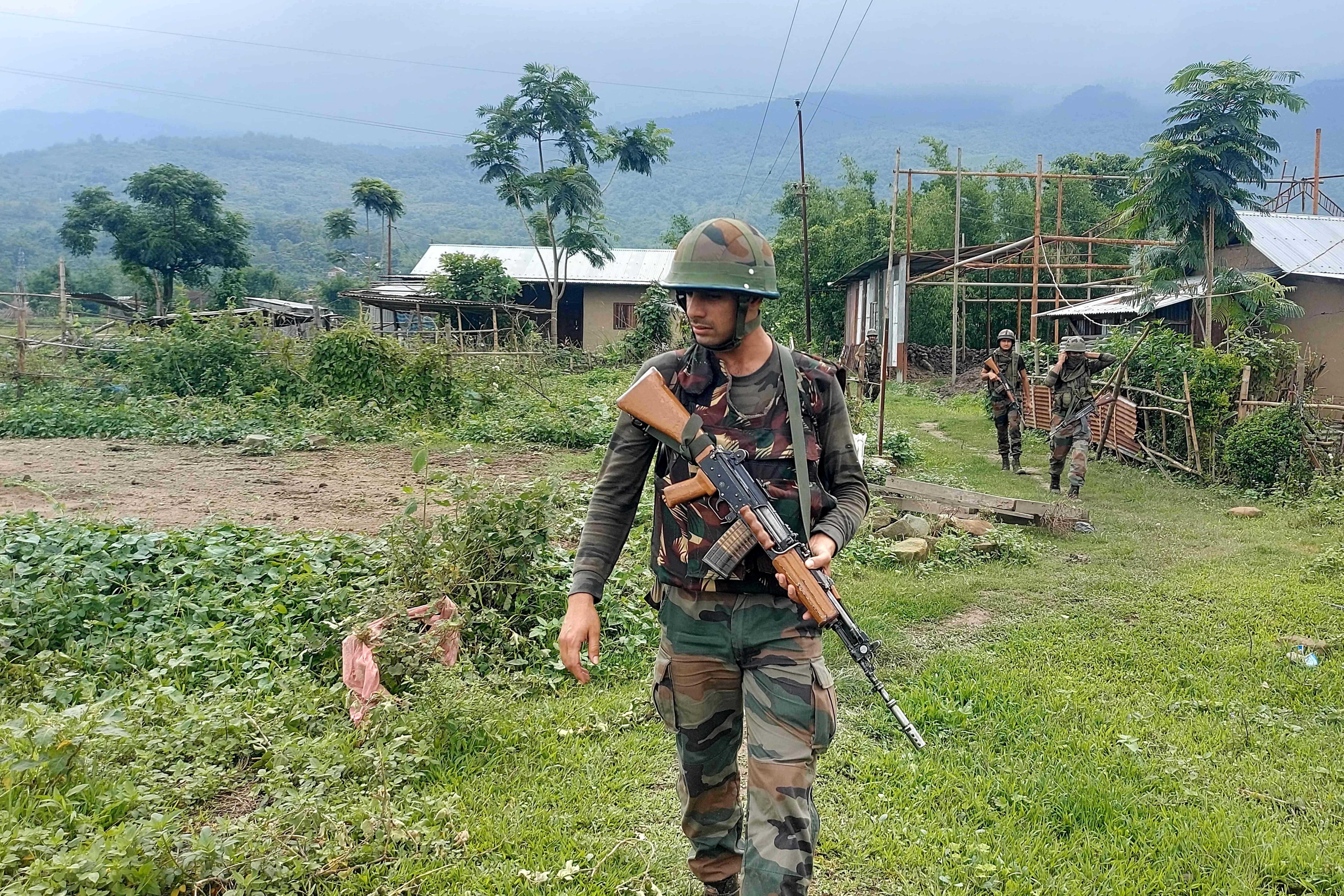 Indian Army personnel patrol during a combing operation at Kanto Sabal village near Imphal