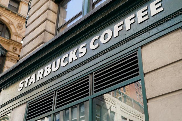 <p>A Starbucks sign sits above a store in the Financial District of Lower Manhattan, Tuesday, June 13, 2023, in New York</p>