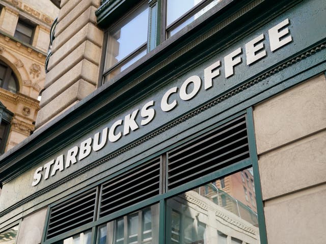 <p>A Starbucks sign sits above a store in the Financial District of Lower Manhattan, Tuesday, June 13, 2023, in New York</p>