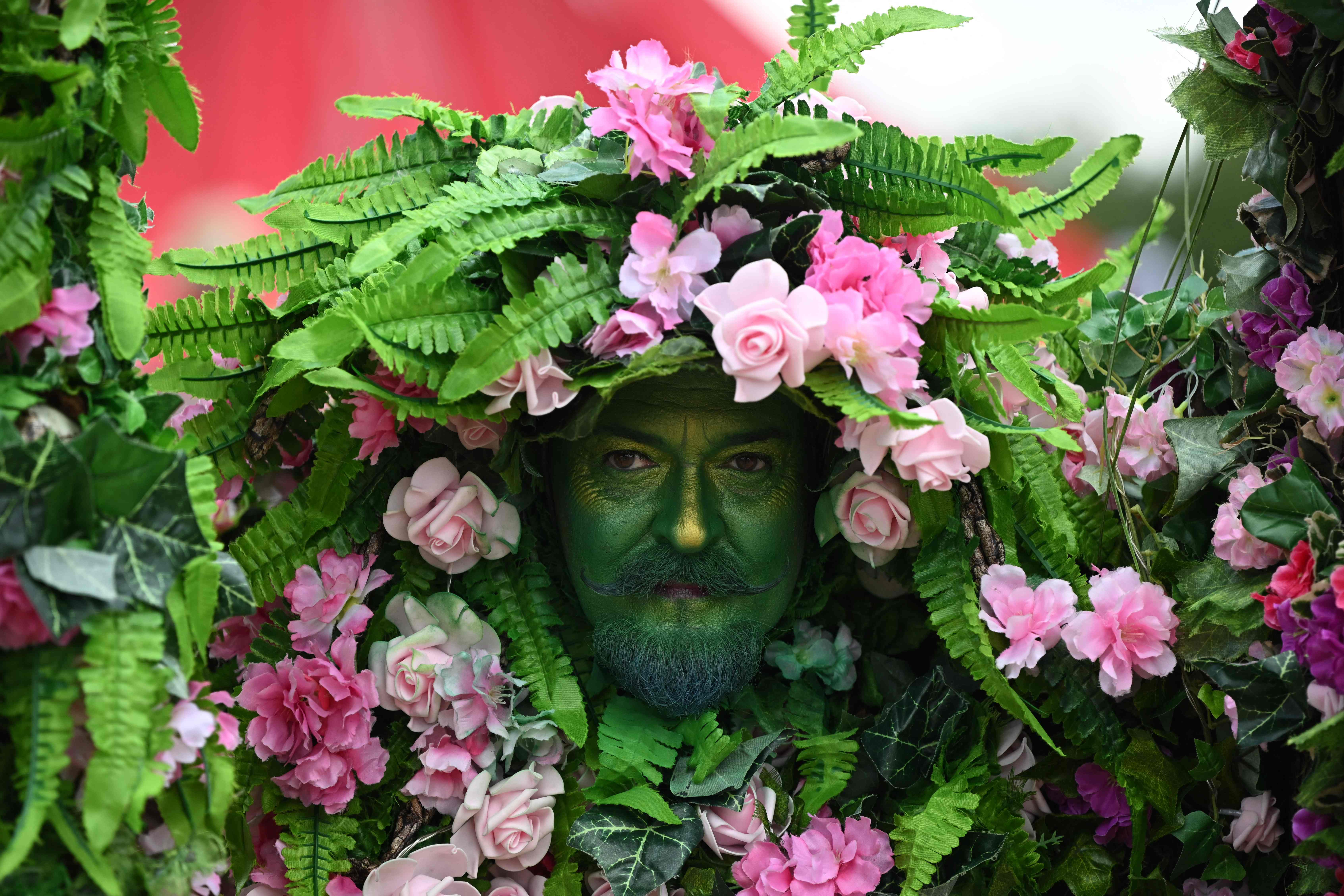 A performer entertains festivalgoers in the circus field at Glastonbury festival