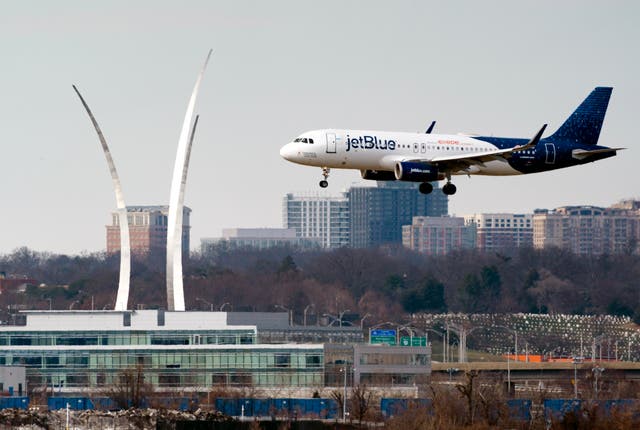 <p>A JetBlue passenger flight lands at Reagan Washington National Airport in Arlington, Viriginia </p>