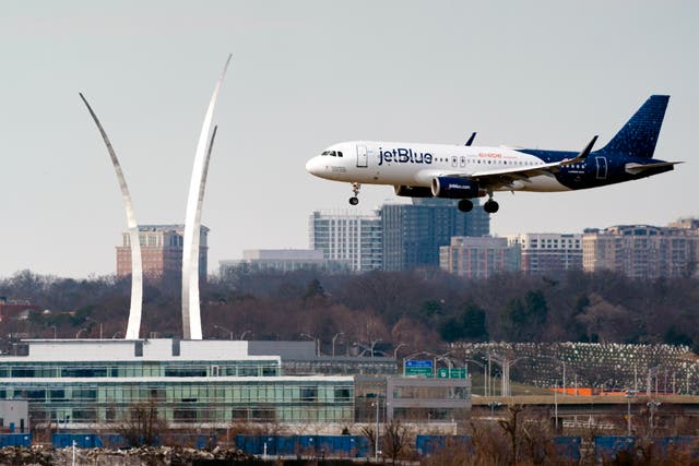 <p>A JetBlue passenger flight lands at Reagan Washington National Airport in Arlington, Viriginia </p>
