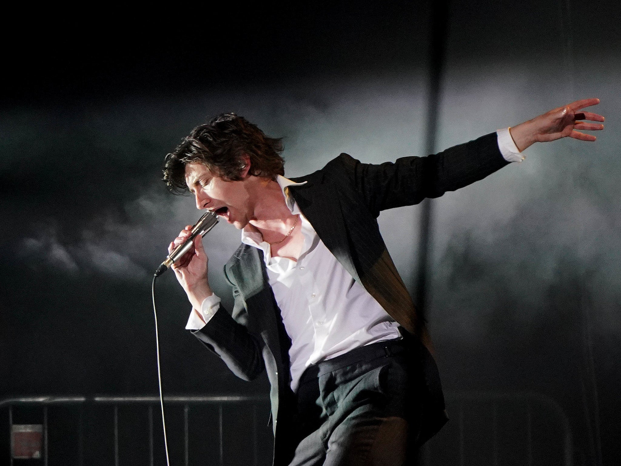 Alex Turner onstage with the Arctic Monkeys at Glastonbury