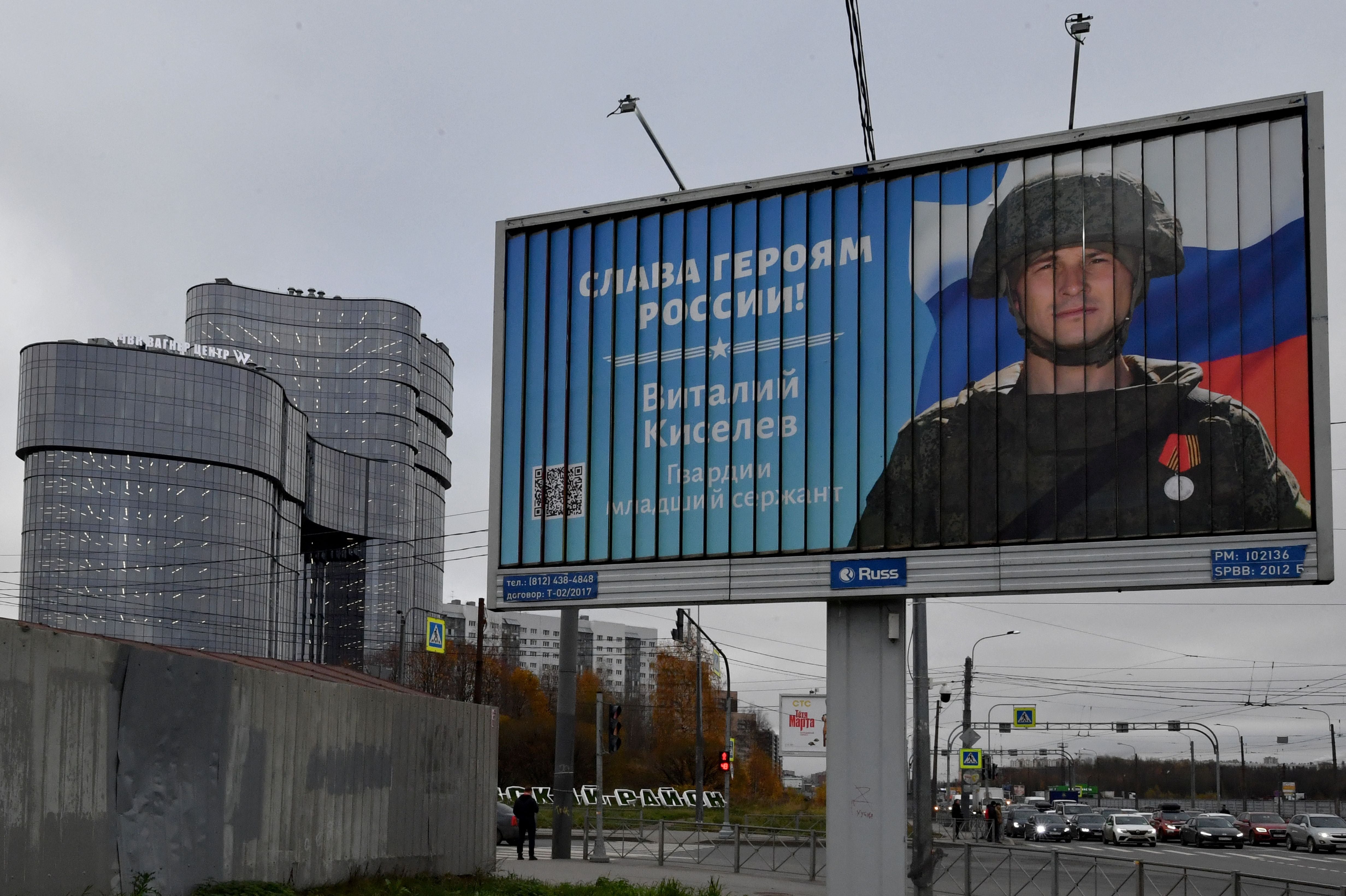 A poster of a Russian soldier with a slogan reading ‘Glory to the heroes of Russia’ opposite the PMC Wagner Centre in St Petersburg