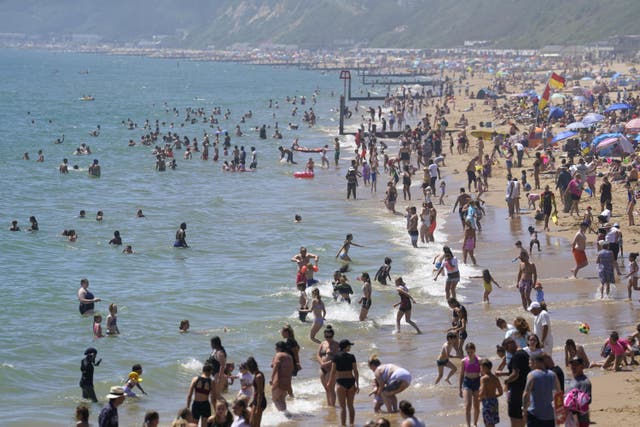 People enjoying the warm weather on Bournemouth beach in Dorset (Andrew Matthews/PA)