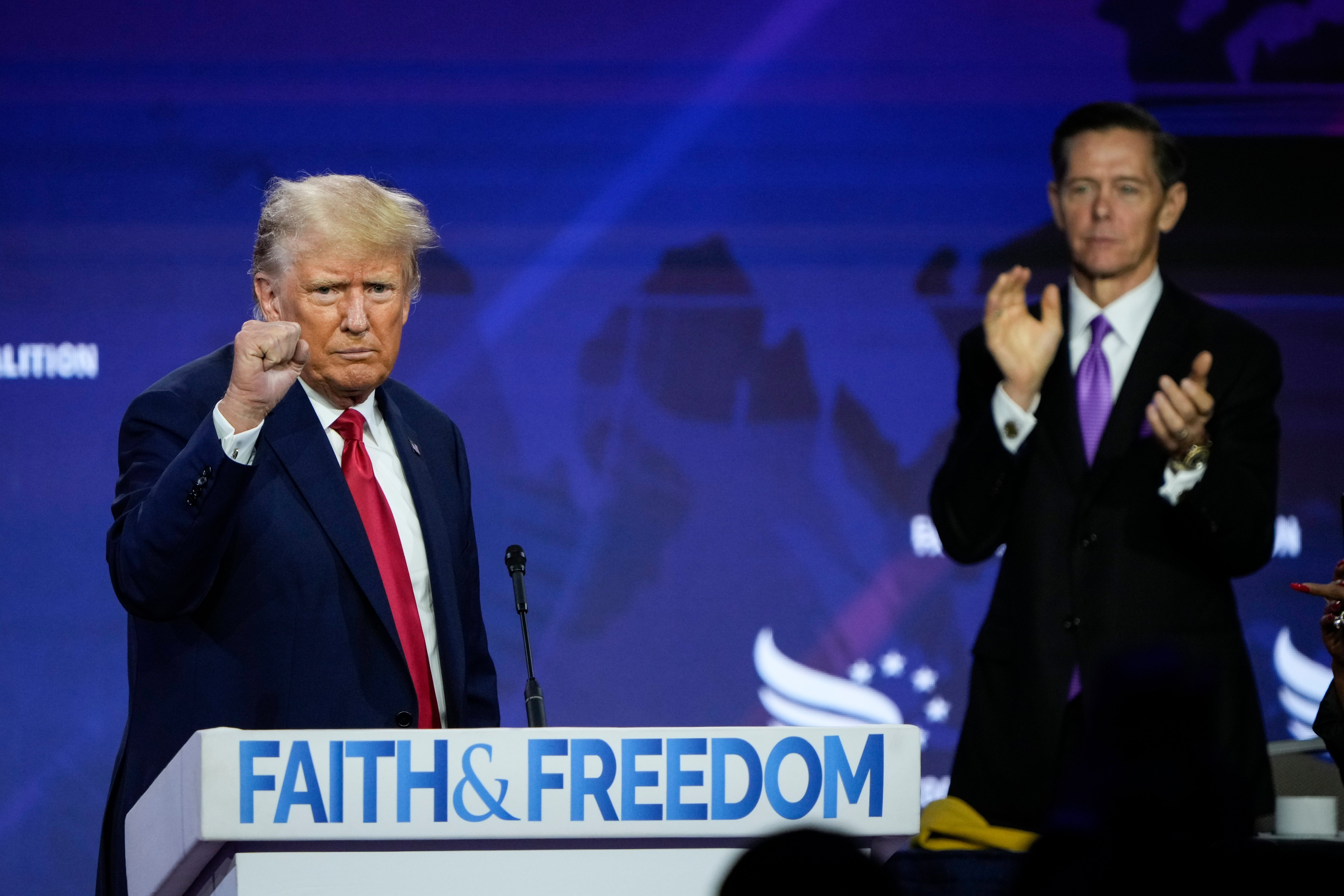 Donald Trump concludes his remarks as Chairman of the Faith and Freedom Coalition Ralph Reed applauds at the Faith and Freedom Road to Majority conference at the Washington Hilton on June 24, 2023 in Washington, DC.