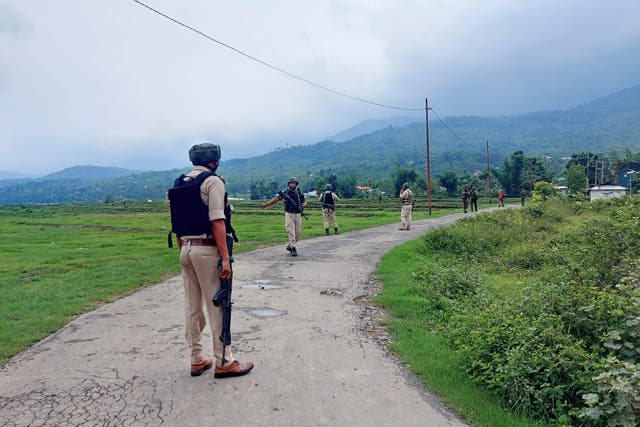 <p>Indian Army and police personnel patrol during a combing operation at Kanto Sabal village near Imphal on 20 June 2023, during ongoing ethnic violence in India’s north-eastern Manipur stat</p>