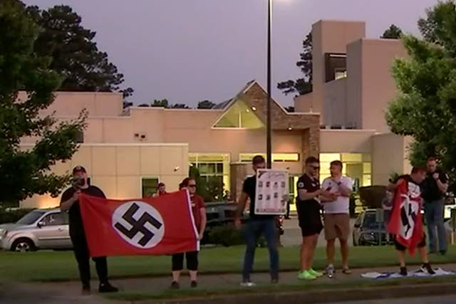 <p>A neo-Nazi group stood outside a synagogue in Georgia during Friday’s  Shabbat service, brandishing swastikas </p>