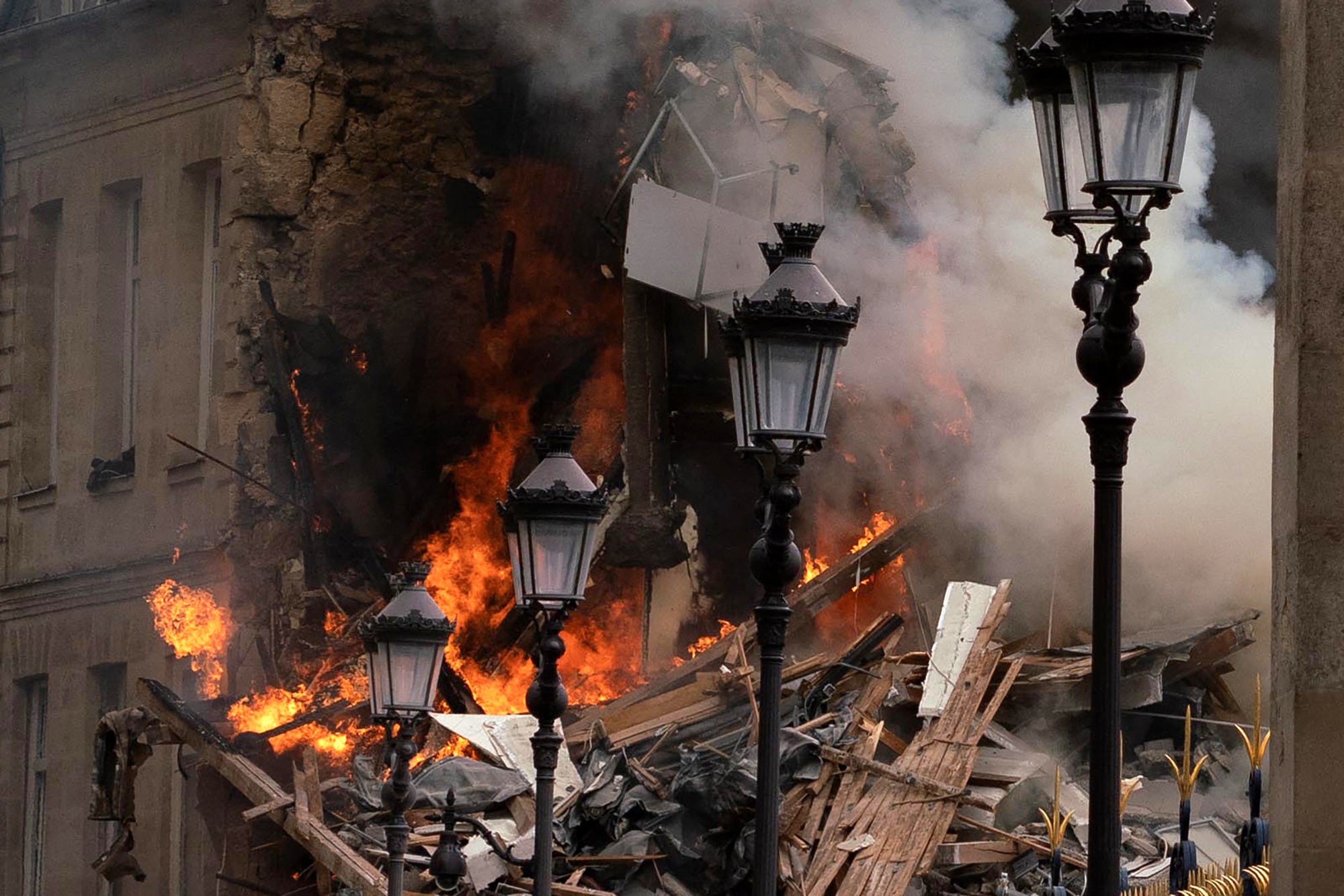 Smoke billows from rubbles of a building at Place Alphonse-Laveran in Paris after a major fire broke out