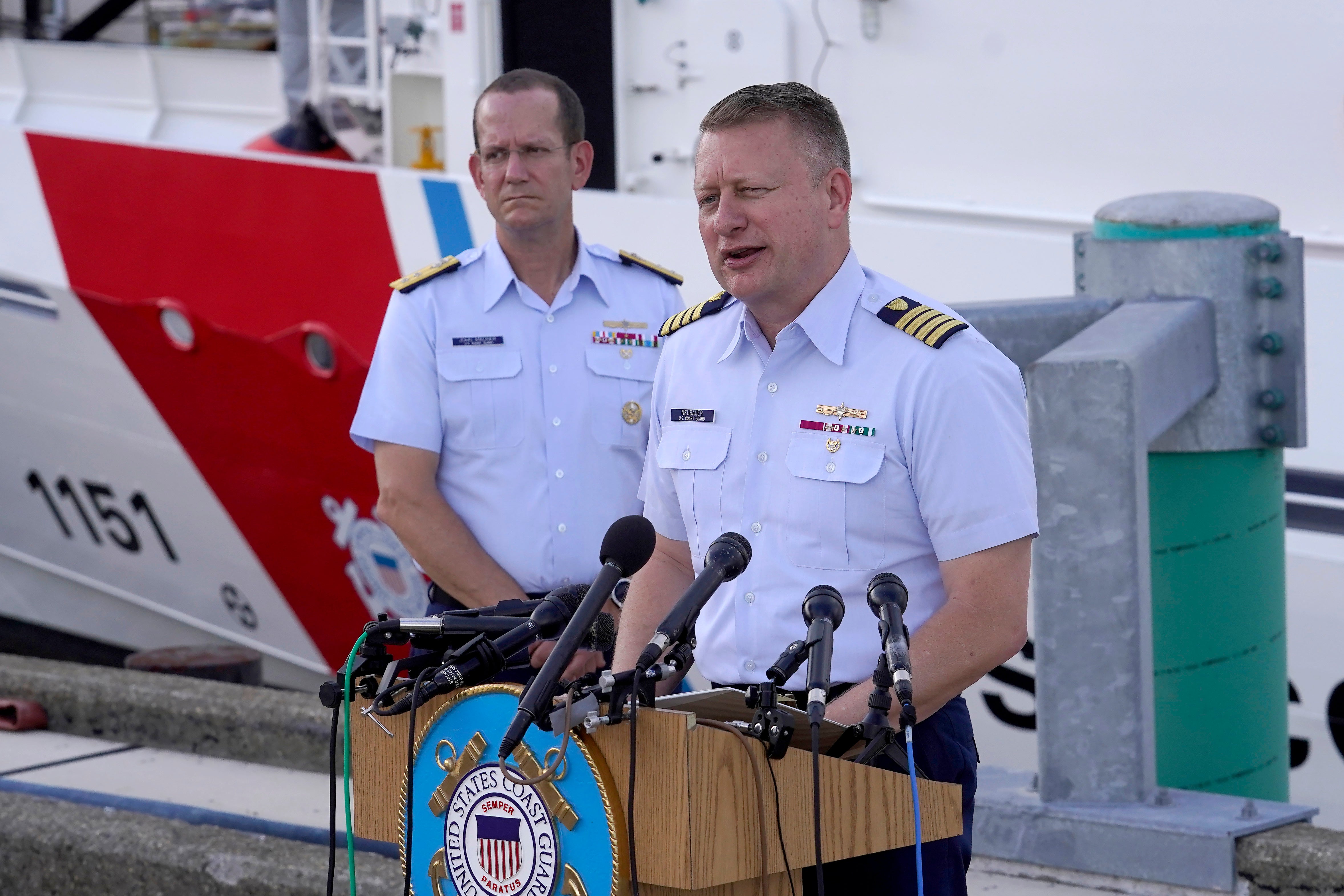 Capt. Jason Neubauer, chief investigator, US Coast, right, speaks with the media along with US.Coast Guard Rear Adm. John MaUGER