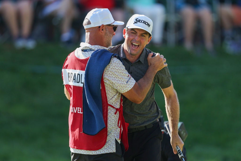 Keegan Bradley and caddie Scott Vail celebrate winning on the 18th green