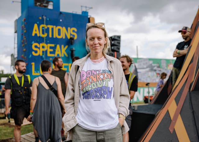 <p>Festival organiser Emily Eavis wearing a Greenpeace ‘Don’t Stop Thinking About Tomorrow’ T-shirt at Glastonbury 2023</p>