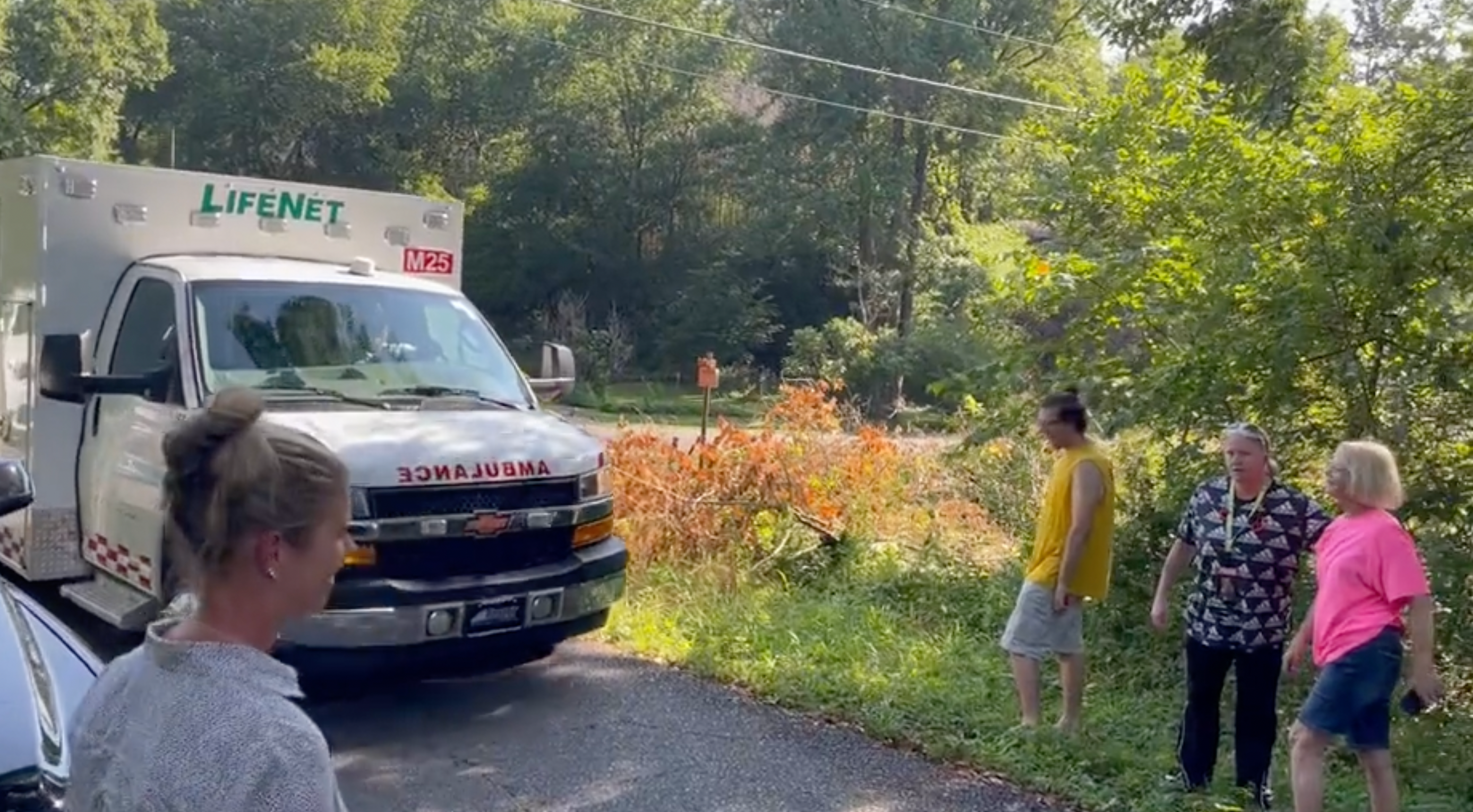 Ambulance arrives at the scene of a plane crash in Lake Hamilton, Arkansas
