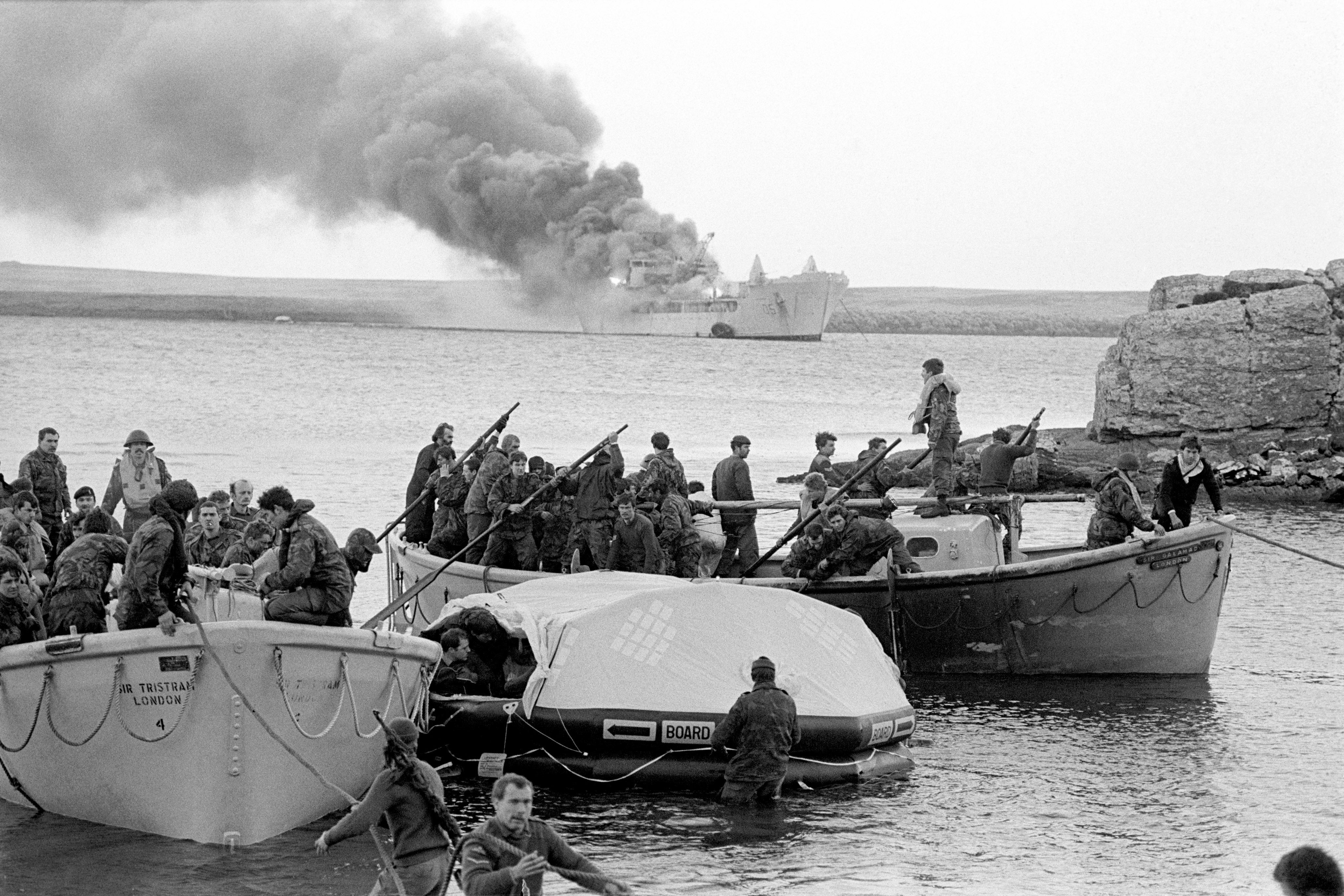 Survivors coming ashore from the Sir Galahad, after it was hit by an Argentinian air attack at Bluff Cove, the Falkland Islands