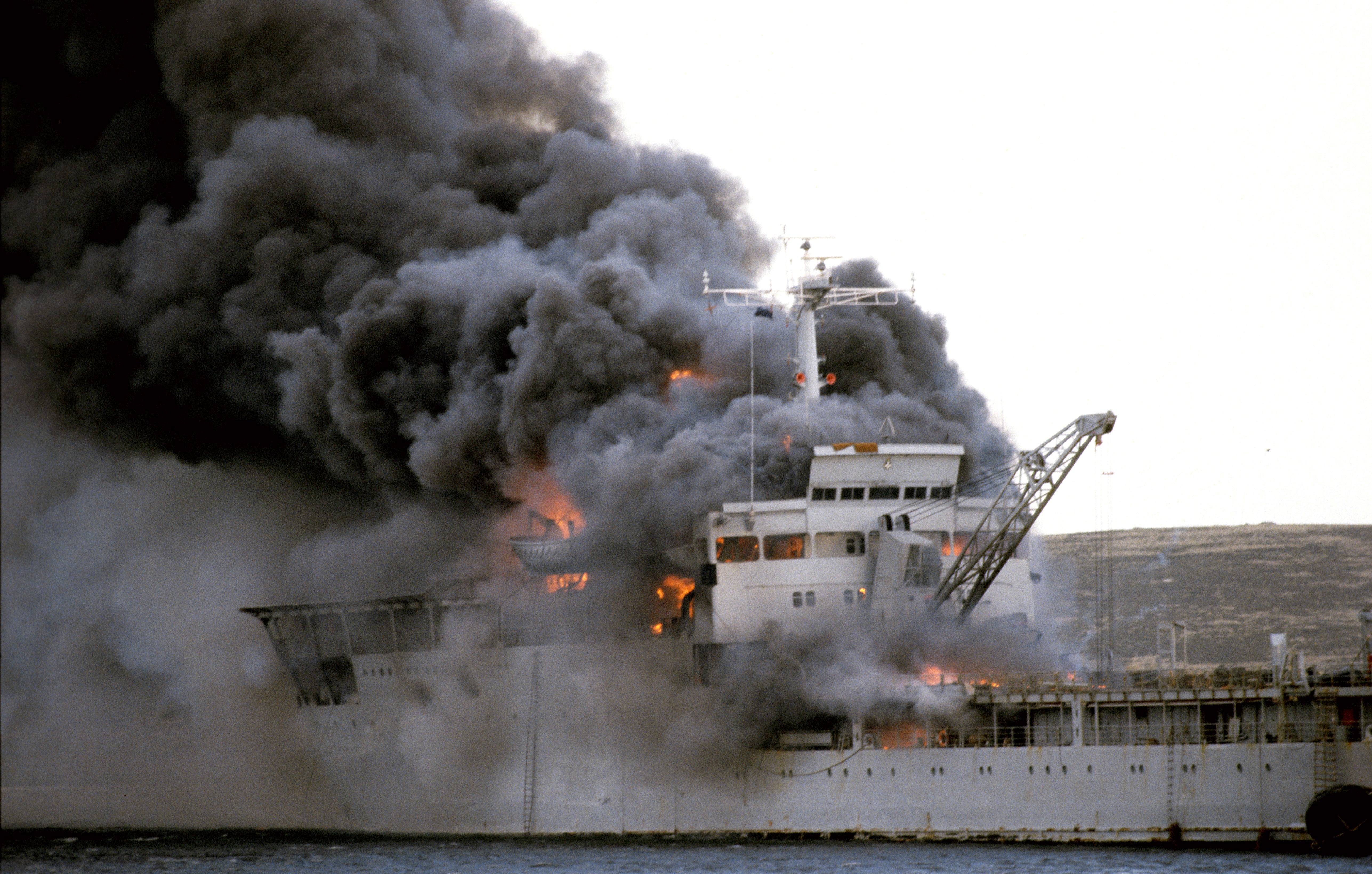 Landing Ship Logistic RFA Sir Galahad ablaze after the Argentine air raid on June 8th at Bluff Cove near Fitzroy settlement on East Falkland