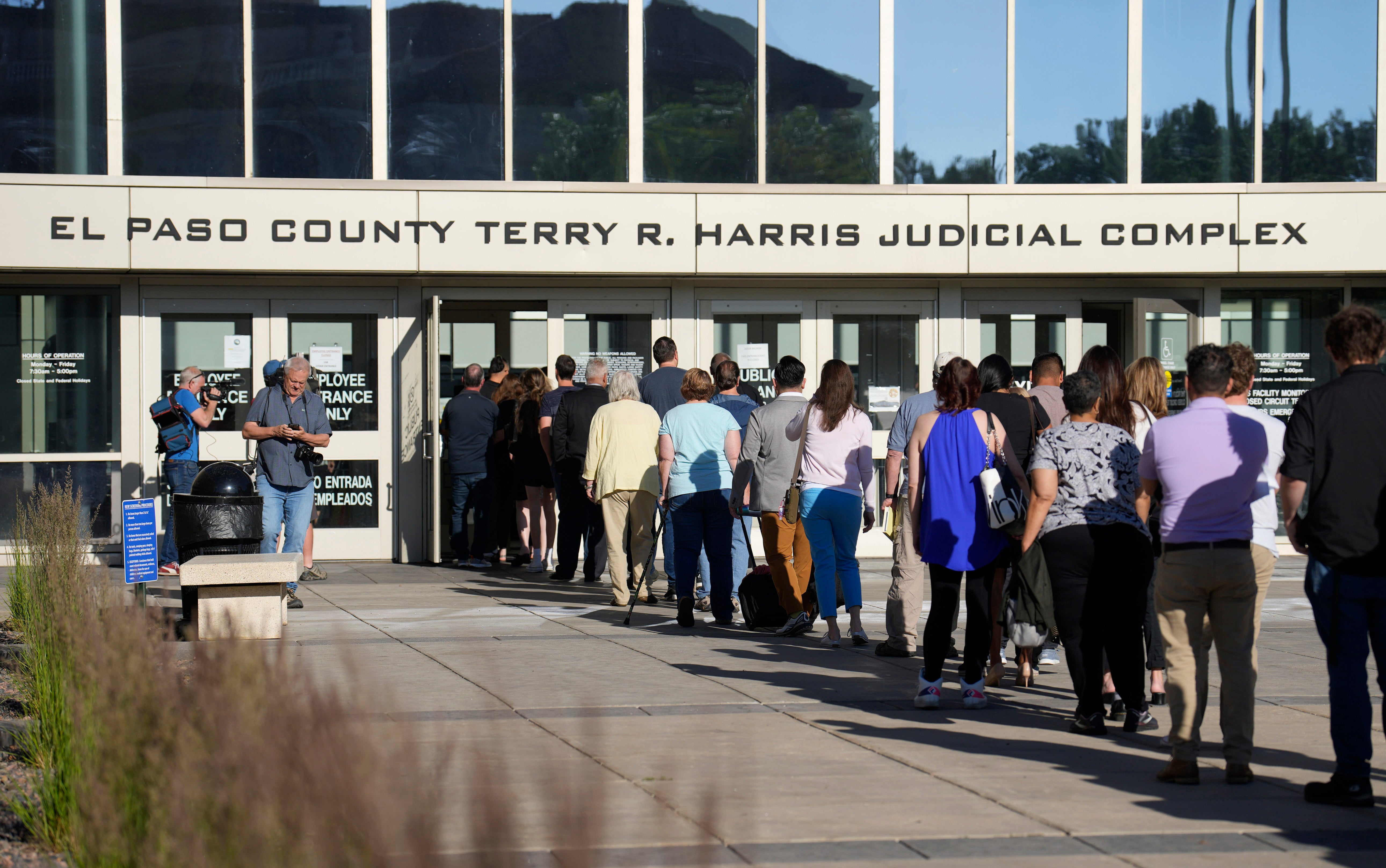 A long line of people wait to clear security to enter the El Paso County Terry R. Harris Judicial Complex, Monday, June 26, 2023, in Colorado Springs, Colo.