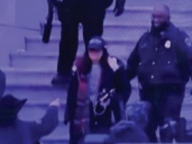 <p>Pam Hemphill being led out of the Capitol following the riot on 6 January</p>