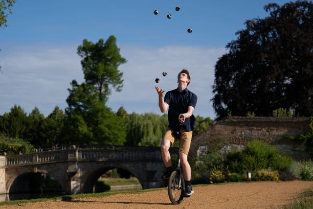 Cambridge University student James Cozens has equalled a Guinness World Record for ‘the most objects juggled while riding a unicycle’, achieving a total of seven balls for a period of 16.77 seconds (Joe Giddens/PA)