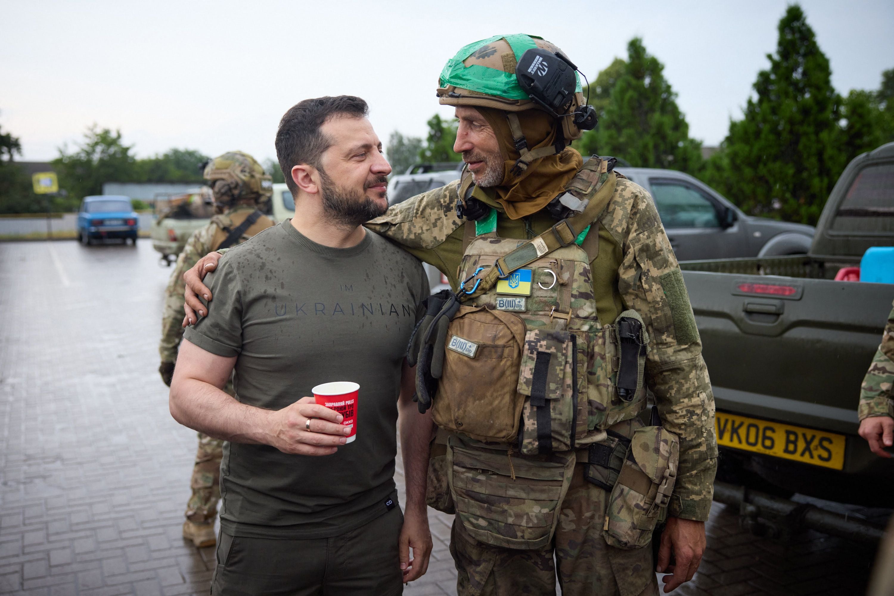 Zelensky poses with a serviceman at a gas station during a visit to the Donetsk region on 26 June 2023