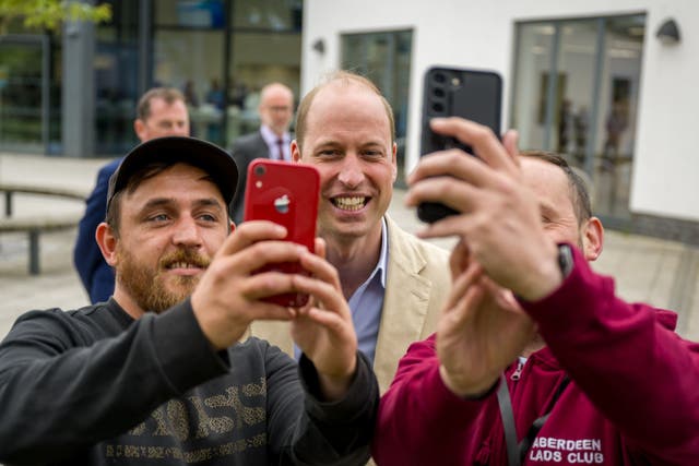 The Prince of Wales has a selfie taken during a visit to Tillydrone Community Campus, Aberdeen, (Euan Duff/PA)