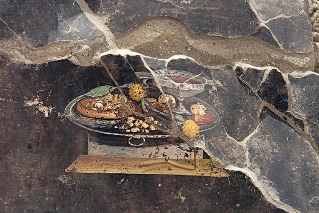 <p>The still life fresco is 2,000 years old and depicts an ancestor of the pizza</p>